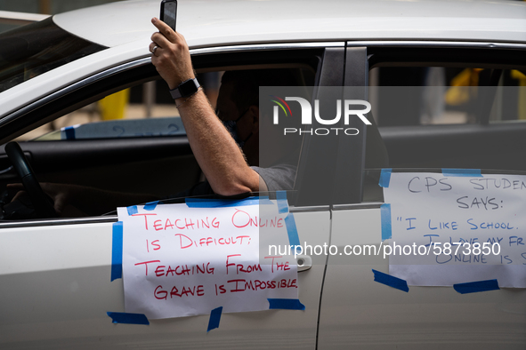 Chicago Teachers Union members and supporters join a car caravan outside Chicago Public Schools (CPS) headquarters while a Chicago Board of...