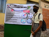 A High school student wear face mask as she wait outside the entrance of Girls Junior Grammar School, S.W, Ikoyi, Lagos on August 3, 2020 on...