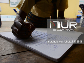 A High school student record her temperature check in a school register at the entrance of Girls Junior Grammar School, S.W, Ikoyi, Lagos on...