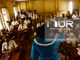 A teacher gives a lesson to students at Girls Junior Grammar School, S.W, Ikoyi, Lagos on August 3, 2020 on the first day after resumption o...