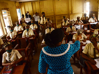 A teacher gives a lesson to students at Girls Junior Grammar School, S.W, Ikoyi, Lagos on August 3, 2020 on the first day after resumption o...