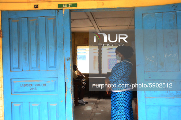 A teacher gives a lesson to students at Girls Junior Grammar School, S.W, Ikoyi, Lagos on August 3, 2020 on the first day after resumption o...