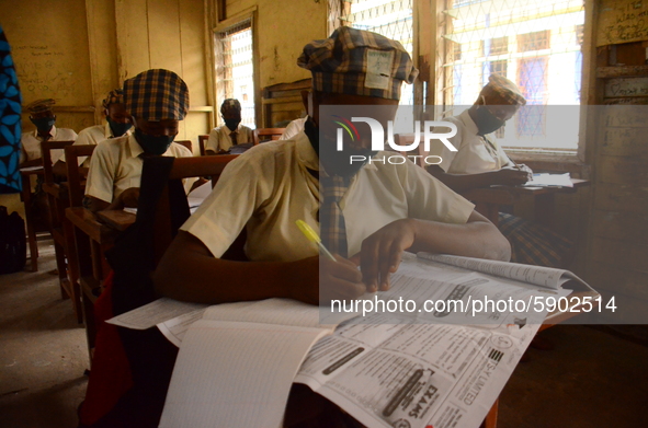 A High School female student wears a face mask while she reads in a classroom at Girls Junior Grammar School, S.W, Ikoyi, Lagos on August 3,...