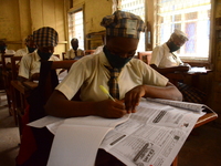 A High School female student wears a face mask while she reads in a classroom at Girls Junior Grammar School, S.W, Ikoyi, Lagos on August 3,...