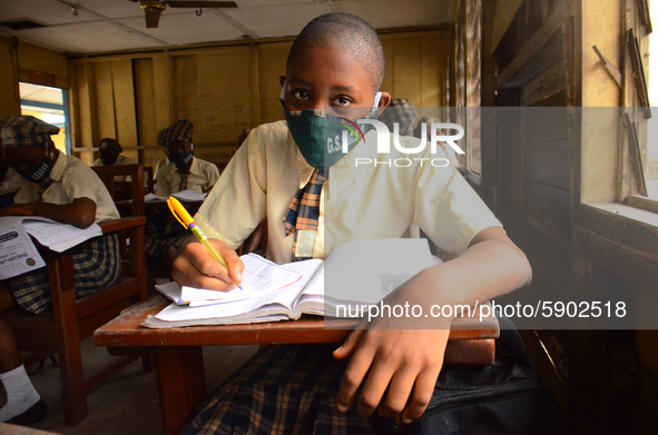 A High School female student wears a face mask while she reads in a classroom at Girls Junior Grammar School, S.W, Ikoyi, Lagos on August 3,...