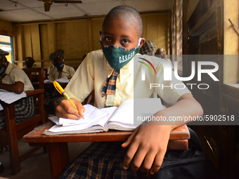 A High School female student wears a face mask while she reads in a classroom at Girls Junior Grammar School, S.W, Ikoyi, Lagos on August 3,...