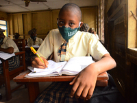 A High School female student wears a face mask while she reads in a classroom at Girls Junior Grammar School, S.W, Ikoyi, Lagos on August 3,...