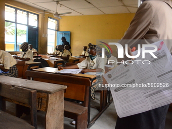 A teacher gives a lesson to students at Girls Junior Grammar School, S.W, Ikoyi, Lagos on August 3, 2020 on the first day after resumption o...