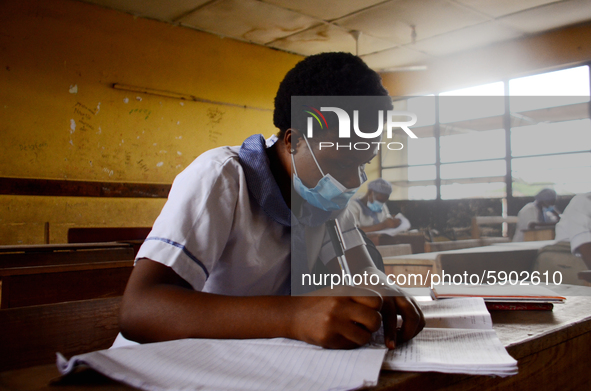 High School students wears a face mask while they reads in a classroom at Ireti Junior Grammar Schol, Ikoyi, Lagos on August 3, 2020 on the...