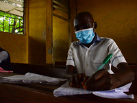 High School students wears a face mask while they reads in a classroom at Ireti Junior Grammar Schol, Ikoyi, Lagos on August 3, 2020 on the...