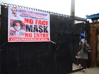 A high school student walks through a gate at Ireti Junior Grammar Schol, Ikoyi, Lagos on August 3, 2020 on the first day after resumption o...