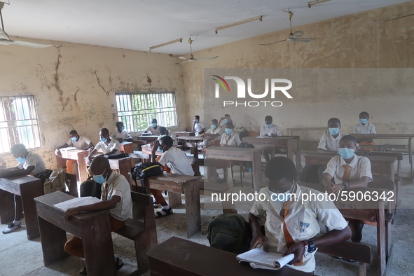 Final year students of Agidingbi Senior Grammar School, Ikeja, Lagos, Nigeria with facemasks sit in a classroom as they resume school after...