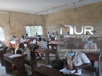 Final year students of Agidingbi Senior Grammar School, Ikeja, Lagos, Nigeria with facemasks sit in a classroom as they resume school after...