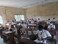 Final year students of Agidingbi Senior Grammar School, Ikeja, Lagos, Nigeria with facemasks sit in a classroom as they resume school after...