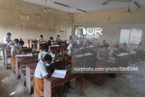 Final year students of Agidingbi Senior Grammar School, Ikeja, Lagos, Nigeria with facemasks sit in a classroom as they resume school after...