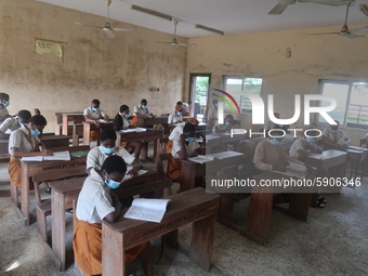 Final year students of Agidingbi Senior Grammar School, Ikeja, Lagos, Nigeria with facemasks sit in a classroom as they resume school after...