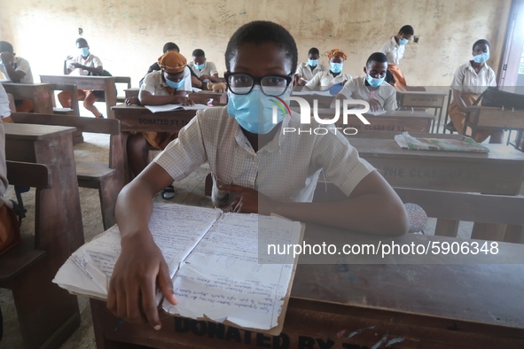 Final year students of Agidingbi Senior Grammar School, Ikeja, Lagos, Nigeria with facemasks sit in a classroom as they resume school after...