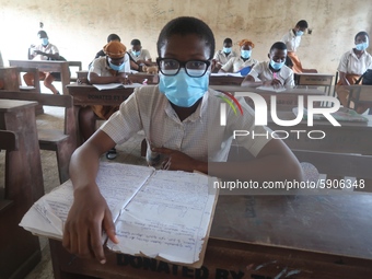 Final year students of Agidingbi Senior Grammar School, Ikeja, Lagos, Nigeria with facemasks sit in a classroom as they resume school after...