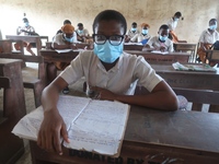 Final year students of Agidingbi Senior Grammar School, Ikeja, Lagos, Nigeria with facemasks sit in a classroom as they resume school after...