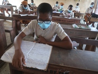 Final year students of Agidingbi Senior Grammar School, Ikeja, Lagos, Nigeria with facemasks sit in a classroom as they resume school after...