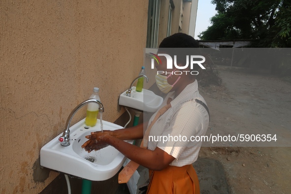 Final year student of Agidingbi Senior Grammar School, Ikeja, Lagos, Nigeria washes her hands as schools resume after COVID-19 lockdown orde...