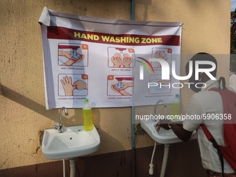 Final year student of Agidingbi Senior Grammar School, Ikeja, Lagos, Nigeria washes his hands as schools resume after COVID-19 lockdown orde...