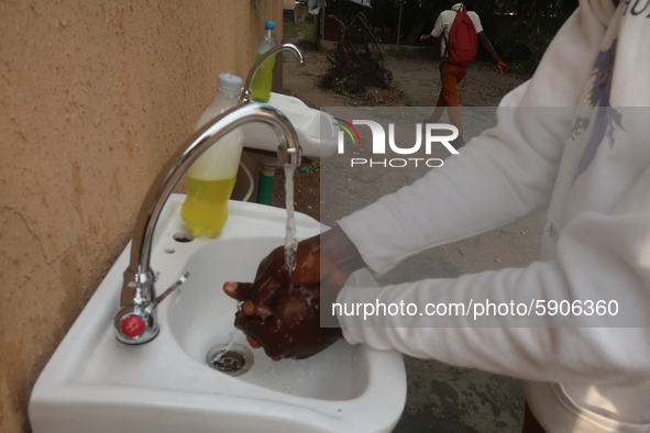 Final year student of Agidingbi Senior Grammar School, Ikeja, Lagos, Nigeria washes his hands as schools resume after COVID-19 lockdown orde...