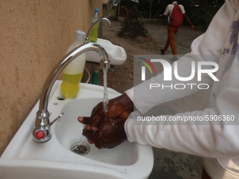 Final year student of Agidingbi Senior Grammar School, Ikeja, Lagos, Nigeria washes his hands as schools resume after COVID-19 lockdown orde...