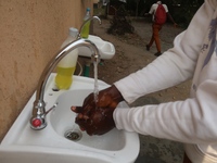 Final year student of Agidingbi Senior Grammar School, Ikeja, Lagos, Nigeria washes his hands as schools resume after COVID-19 lockdown orde...