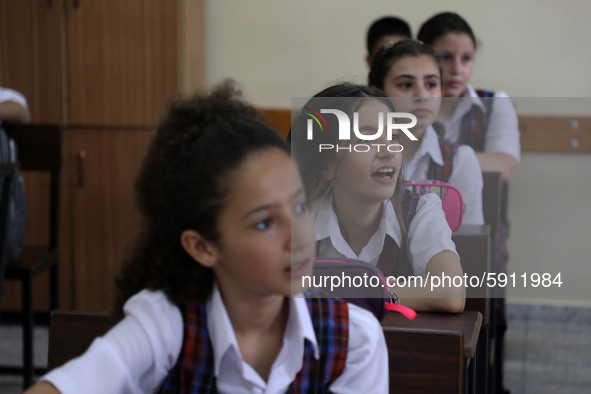 Palestinian schoolchildren sit inside a classroom in the rosary sisters school gaza , on the first day of a new school year, as Palestinians...