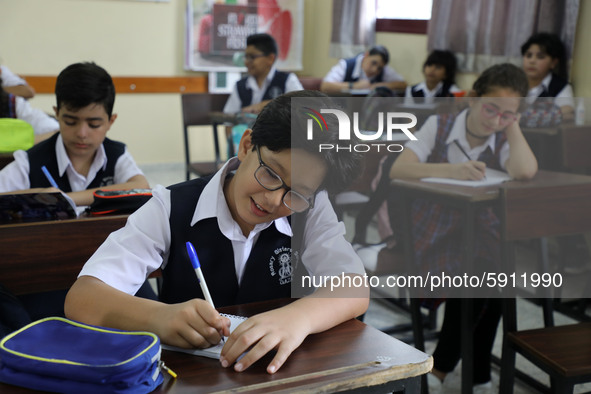 Palestinian schoolchildren sit inside a classroom in the rosary sisters school gaza , on the first day of a new school year, as Palestinians...