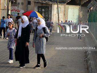 Students walk to the United-Nation run Elementary School on the first day of the new school year as Palestinians ease the coronavirus diseas...