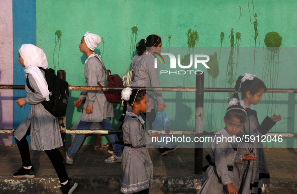 Students walk to the United-Nation run Elementary School on the first day of the new school year as Palestinians ease the coronavirus diseas...