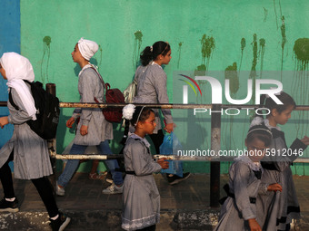 Students walk to the United-Nation run Elementary School on the first day of the new school year as Palestinians ease the coronavirus diseas...