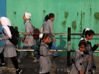 Students walk to the United-Nation run Elementary School on the first day of the new school year as Palestinians ease the coronavirus diseas...