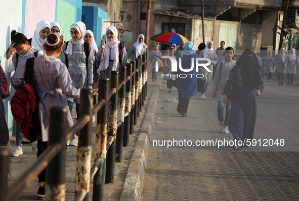 Students walk to the United-Nation run Elementary School on the first day of the new school year as Palestinians ease the coronavirus diseas...