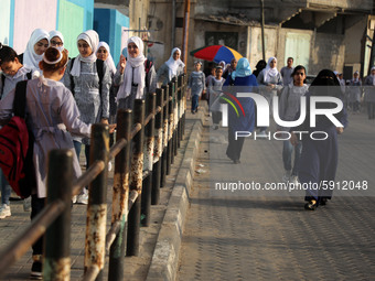 Students walk to the United-Nation run Elementary School on the first day of the new school year as Palestinians ease the coronavirus diseas...