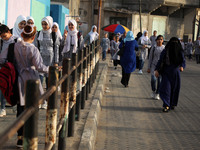 Students walk to the United-Nation run Elementary School on the first day of the new school year as Palestinians ease the coronavirus diseas...