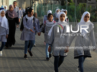 Students walk to the United-Nation run Elementary School on the first day of the new school year as Palestinians ease the coronavirus diseas...