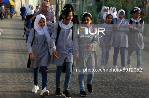 Students walk to the United-Nation run Elementary School on the first day of the new school year as Palestinians ease the coronavirus diseas...