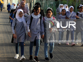 Students walk to the United-Nation run Elementary School on the first day of the new school year as Palestinians ease the coronavirus diseas...