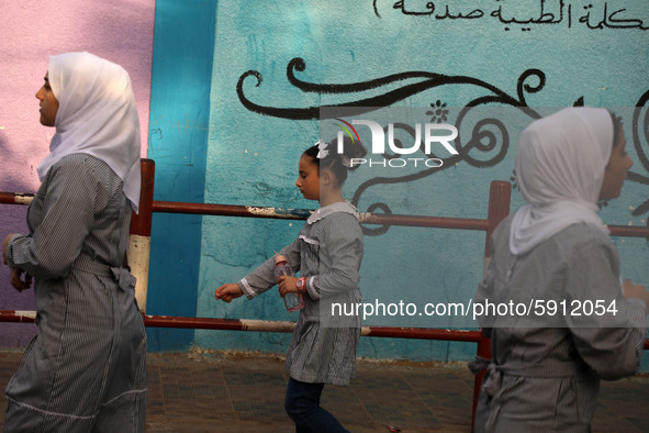 Students walk to the United-Nation run Elementary School on the first day of the new school year as Palestinians ease the coronavirus diseas...