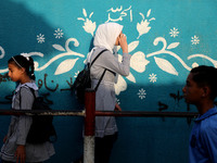 Students walk to the United-Nation run Elementary School on the first day of the new school year as Palestinians ease the coronavirus diseas...