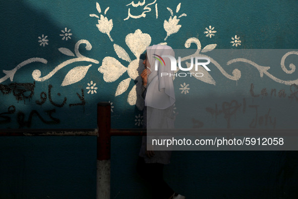 Students walk to the United-Nation run Elementary School on the first day of the new school year as Palestinians ease the coronavirus diseas...