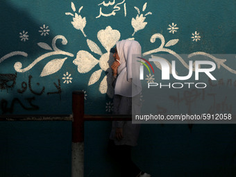 Students walk to the United-Nation run Elementary School on the first day of the new school year as Palestinians ease the coronavirus diseas...