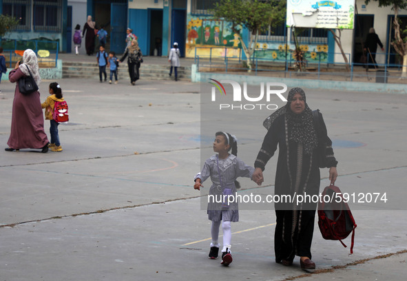 Women bring their children to the United-Nation run Elementary School on the first day of the new school year as Palestinians ease the coron...