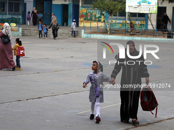 Women bring their children to the United-Nation run Elementary School on the first day of the new school year as Palestinians ease the coron...