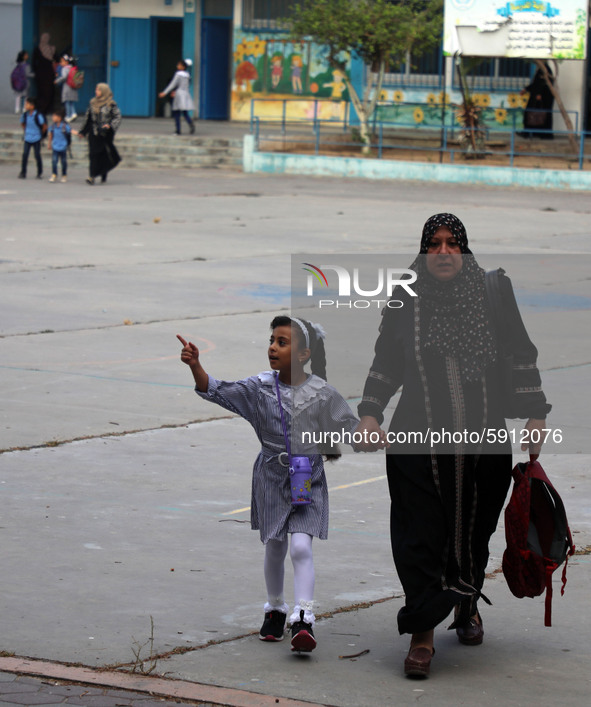 Women bring their children to the United-Nation run Elementary School on the first day of the new school year as Palestinians ease the coron...