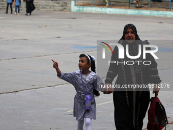 Women bring their children to the United-Nation run Elementary School on the first day of the new school year as Palestinians ease the coron...