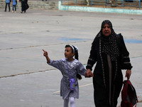 Women bring their children to the United-Nation run Elementary School on the first day of the new school year as Palestinians ease the coron...